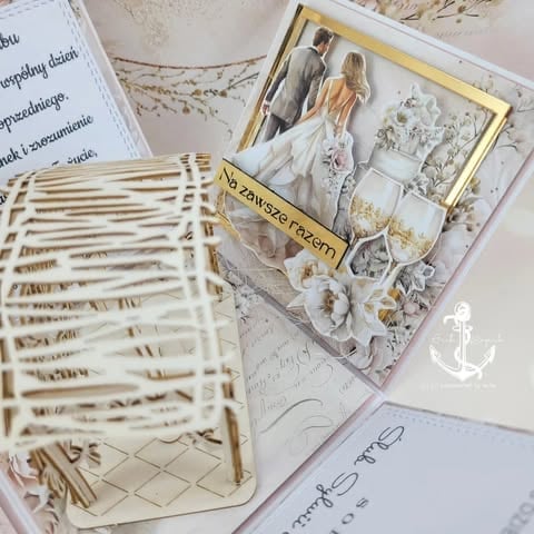 Flat lay of wedding planning materials including invitation sketches, photo mementos in a decorative frame, and handwritten notes with nautical accents.