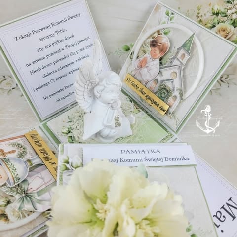 Religious ceremony invitations and mementos with white flowers, candles, and floral decorative elements on display.