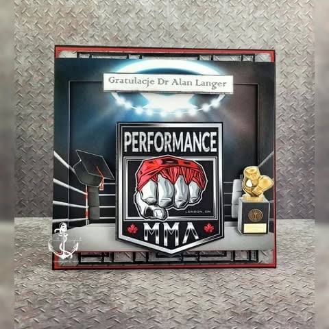 MMA Performance award plaque with clenched fist graphic in red bandana, gold trophy figurine, and 'Gratulacje Dr Alan Langer' text on metallic diamond plate background