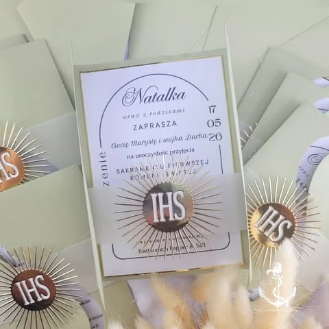 Religious invitation card for Natalka with gold sunburst IHS symbol, decorative elements, and 'Zaprasza Cię Maryla i Darka' text