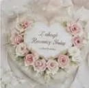 Vintage-style floral wreath with pink roses surrounding elegant calligraphy text on a cream background