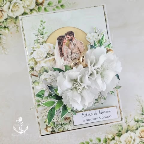Handmade wedding card with couple photo, white 3D peony, gold frame, and 'Estera & Marcin 6 grudnia 2025r.' text on green foliage background