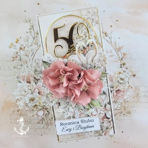 Elegant 50th wedding anniversary card with gold 50 numerals, pink peony 3D flowers, decorative swans, and 'Rocznica Ślubu Ewy i Bogdana' text on cream background