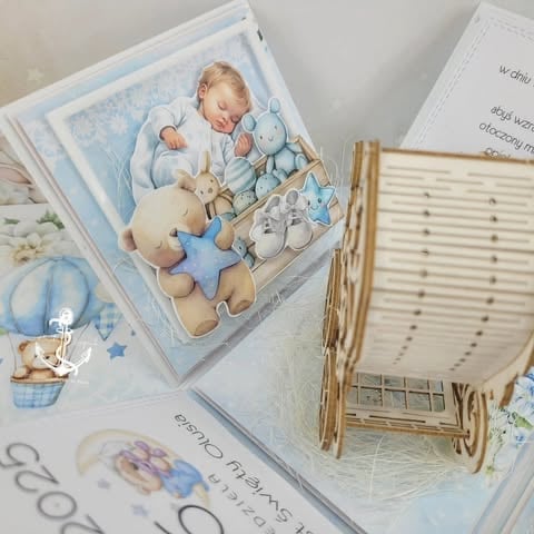 Baby nursery room setup with illustration of sleeping infant with stuffed animals, wooden crib, and blue-themed decor items