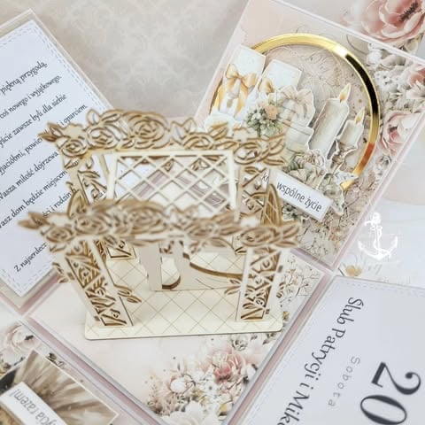Laser-cut wooden decorative elements and floral-patterned invitation cards arranged with vintage styling and metallic accents