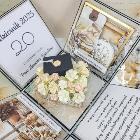 Flat lay of wedding invitation materials including cream flowers, decorative box with supplies, invitation card dated 2025, and coordinating stationery items.