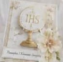 Gold monstrance with IHS symbol on cream decorative card with white flowers