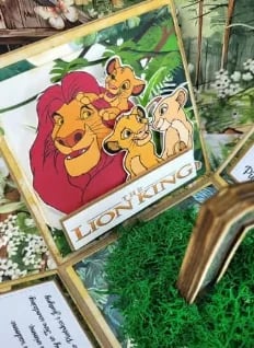 Framed illustration of Lion King characters Mufasa and Simba with decorative foliage and gold frame