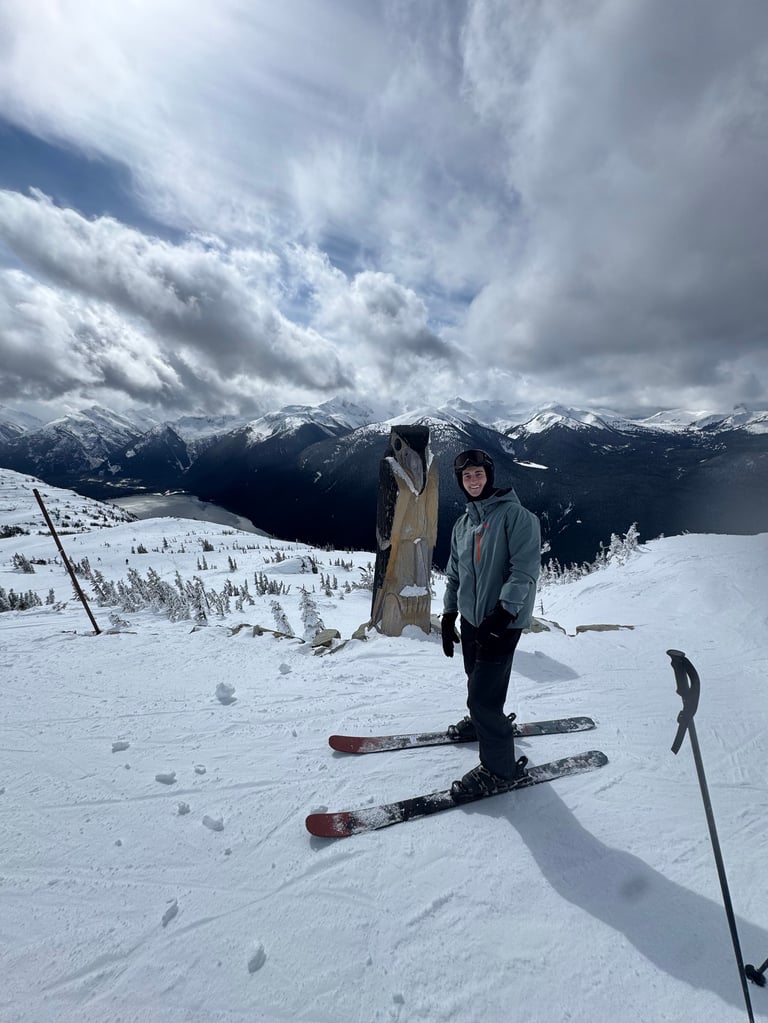 Andrew Donohue skiing on a snowy mountain slope with dramatic clouds