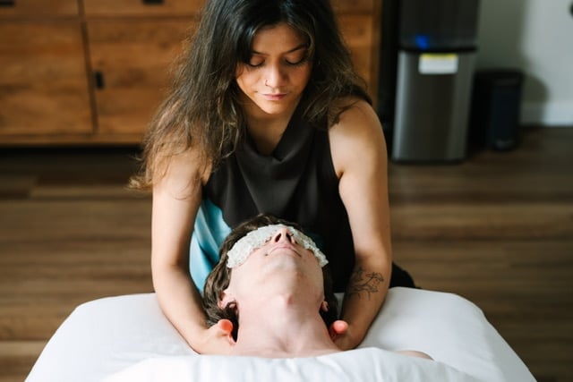 Cat performing a gentle head and neck massage on a client