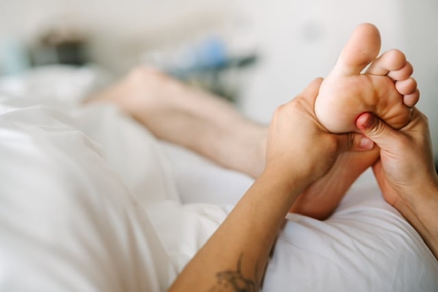 Therapist performing a foot massage on a client's sole