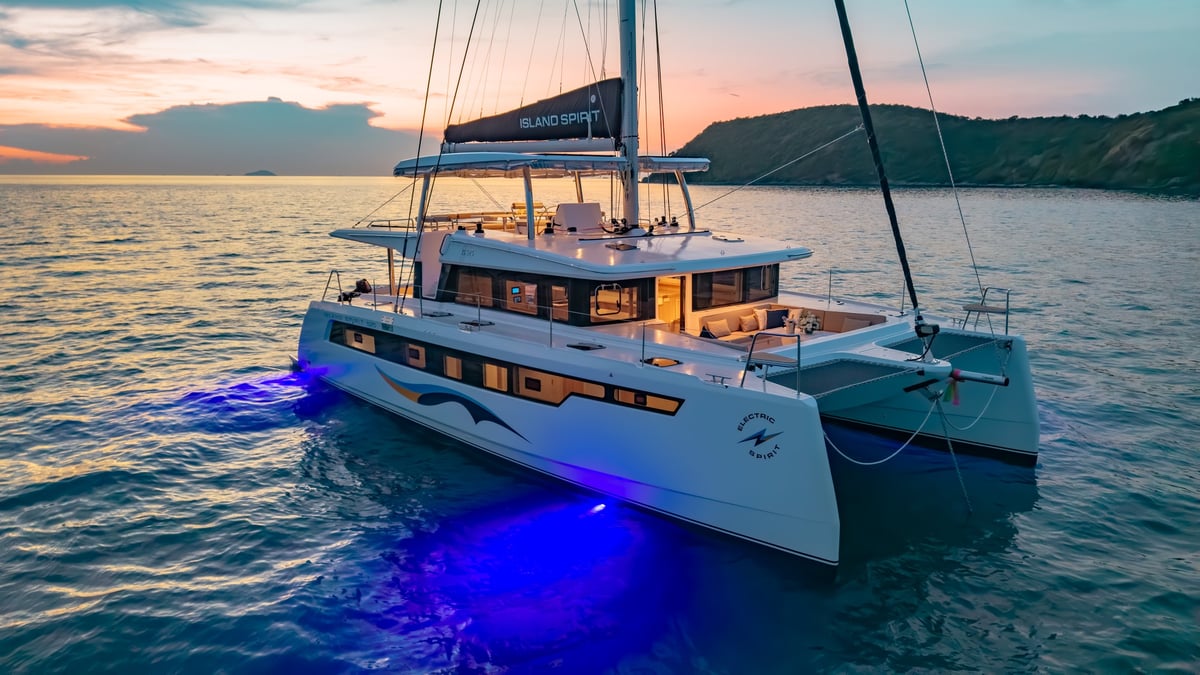 Good Ol' Days — luxury catamaran at sunset with blue underwater lights