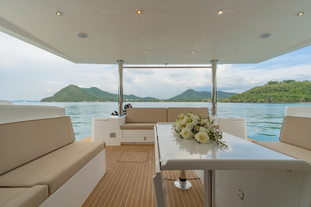 Good Ol' Days — luxury yacht deck with beige seating and panoramic tropical views