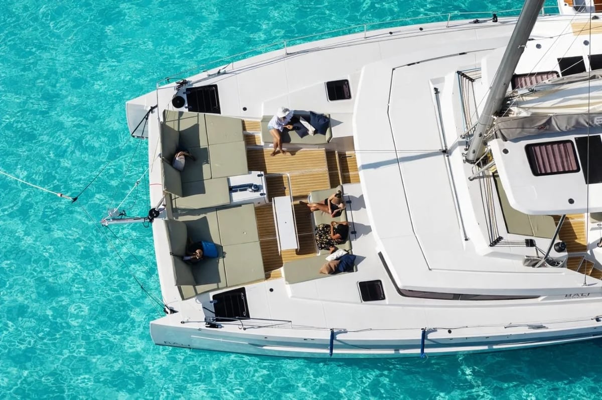 Allegra — aerial view of a white cabin cruiser on turquoise water