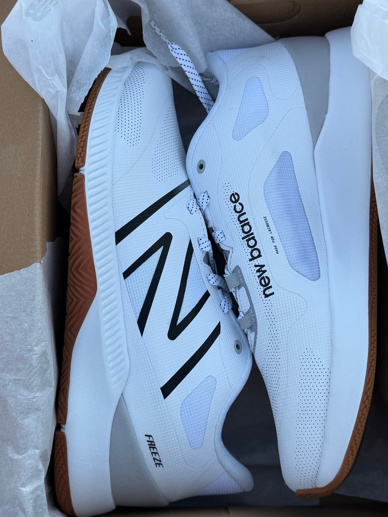 FreezeLX v4 Box white sneakers with black stripes on a blue box
