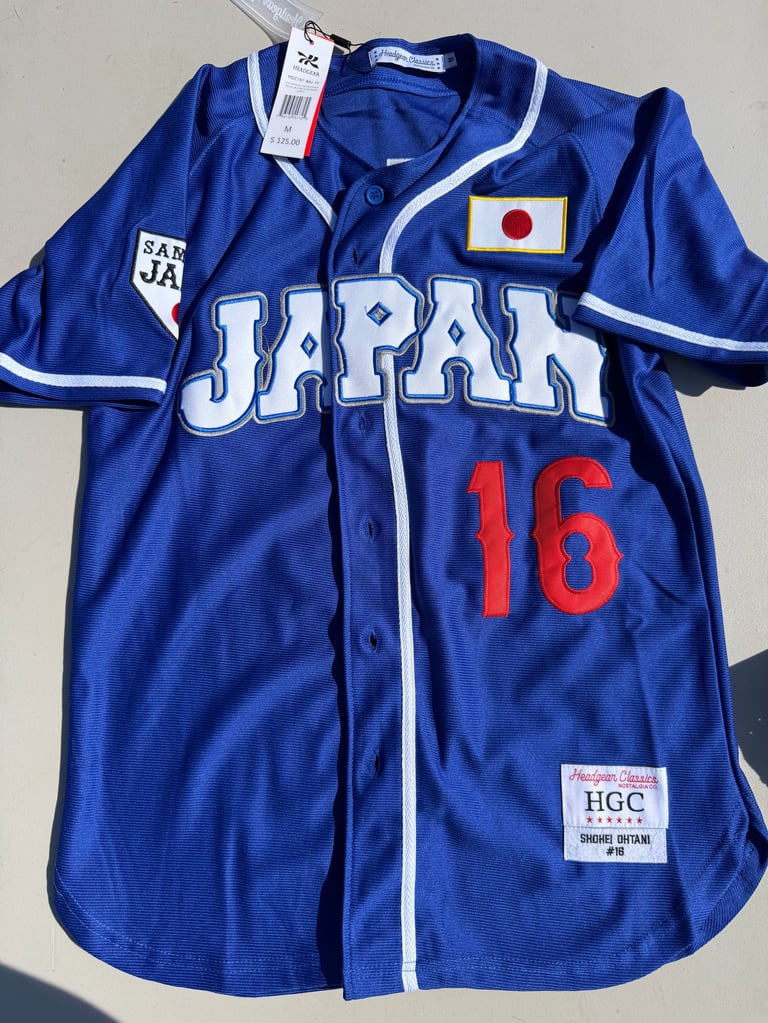 Headgear Classics Samurai Japan Shohei Ohtani Jersey white sneakers with black stripes on a blue box