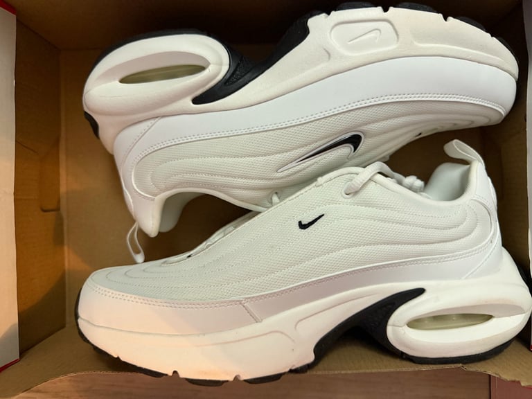 Nike Air Max Portal white sneakers with black stripes on a blue box