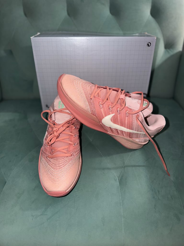 Nike Sabrina 3 Pink Oxford/Coconut Milk white sneakers with black stripes on a blue box