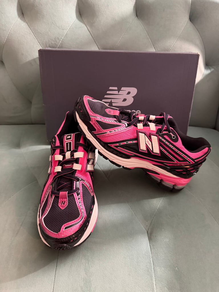 New Balance 1906R Pink Black white sneakers with black stripes on a blue box