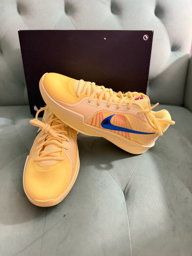Nike Sabrina 2 Citron Tint/Royal Pulse white sneakers with black stripes on a blue box