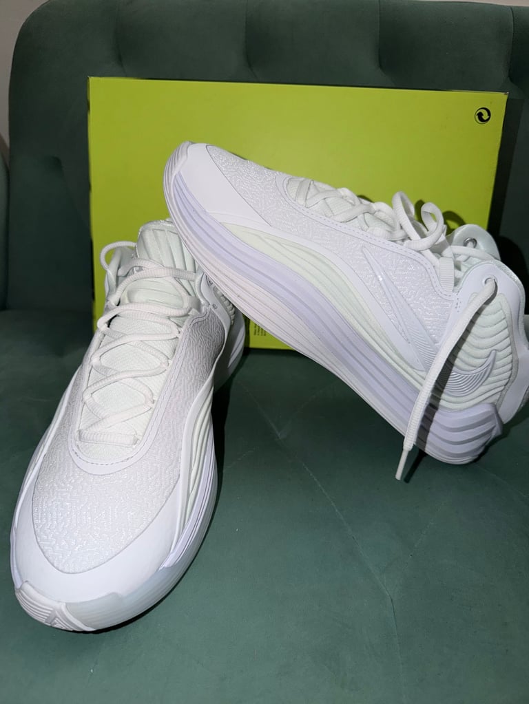 Giannis Freak 7 white sneakers with black stripes on a blue box