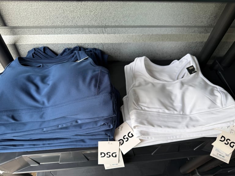 DSG Compression Bra white sneakers with black stripes on a blue box