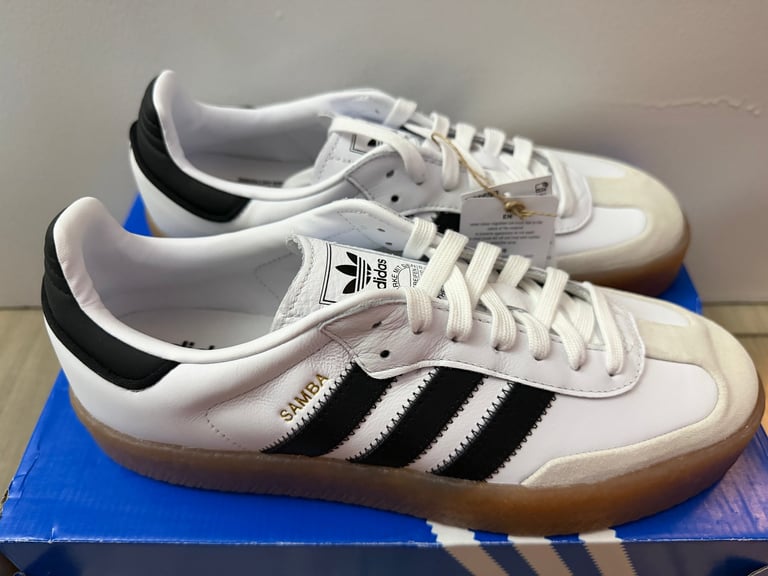 Adidas Sambae white sneakers with black stripes on a blue box